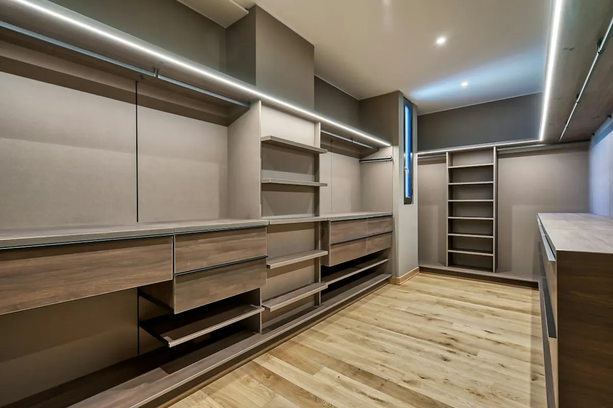 Empty fitted wardrobe with shelves and sliding compartments