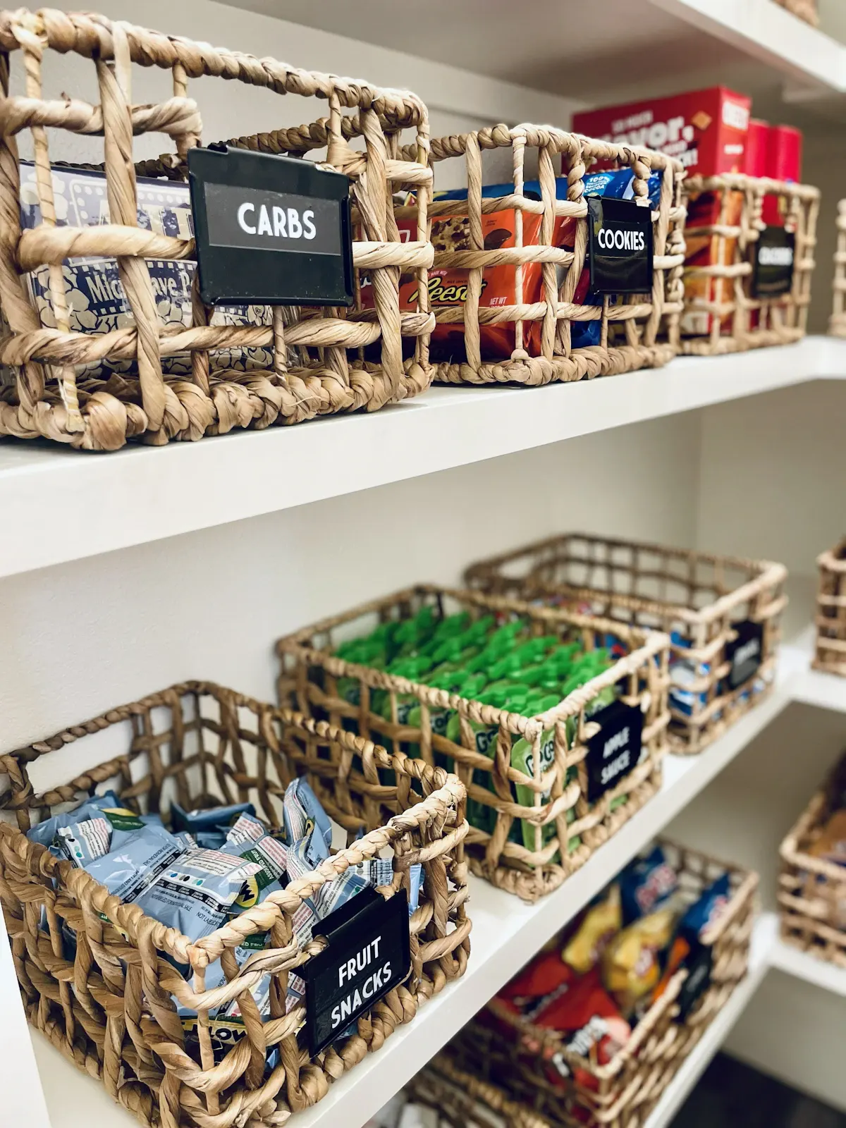 Storage baskets arranged along pantry shelves