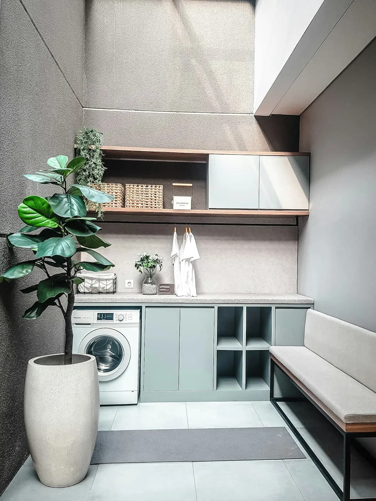 Compact laundry room with fitted shelving and cupboards